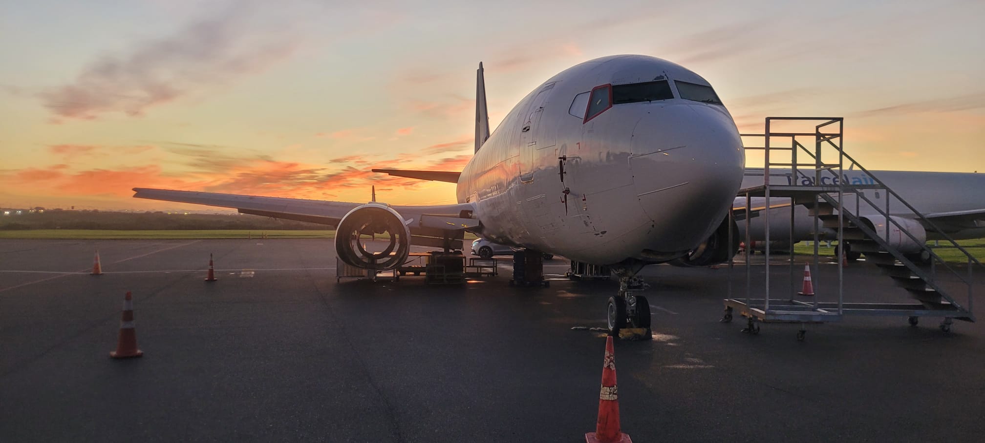Boeing 737 on apron at sunset during aviation engineering operations
