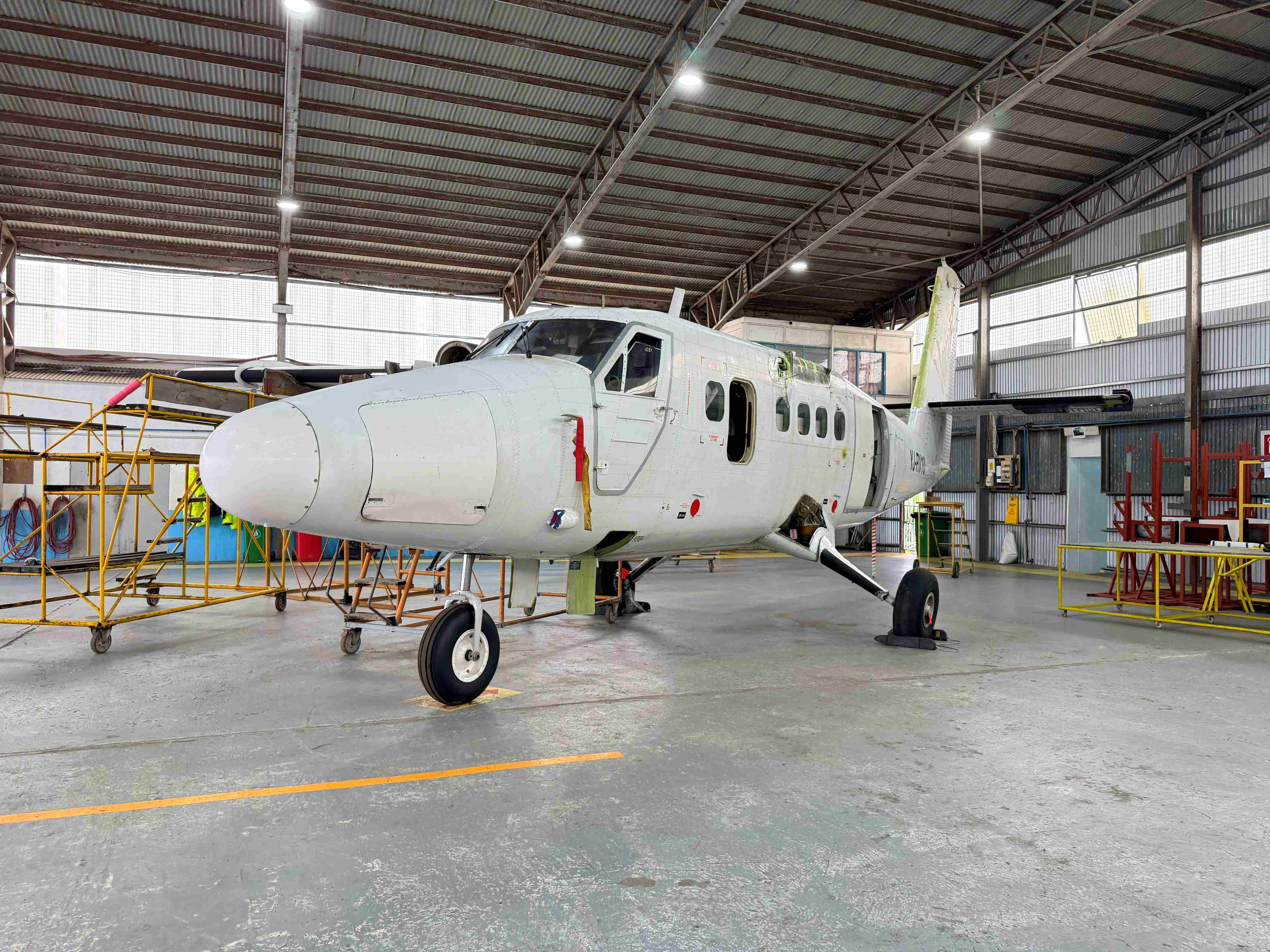 Regional turboprop aircraft in hangar during maintenance preparation